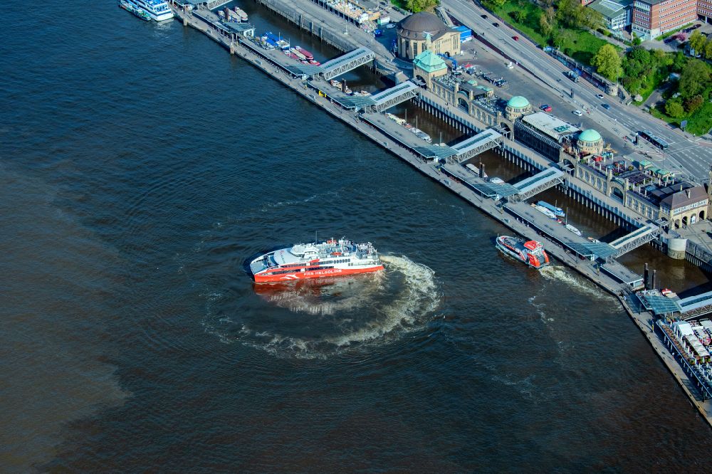Hamburg from above - Travel of a ferry ship Katamaran Halunder Jet der FRS Reederei in Hamburg in front of the Landungsbruecken in the state Lower Saxony, Germany