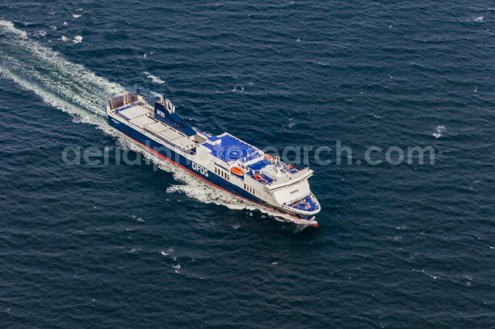 Strande from the bird's eye view: Travel of a ferry ship on the Baltic Sea entering the Kiel Fjord in Strande in the state Schleswig-Holstein, Germany. The freight ferry ATHENA SEAWAYS ( IMO 9350680 ) of the shipping company DFDS runs shuttle services between Kiel and Lithuania