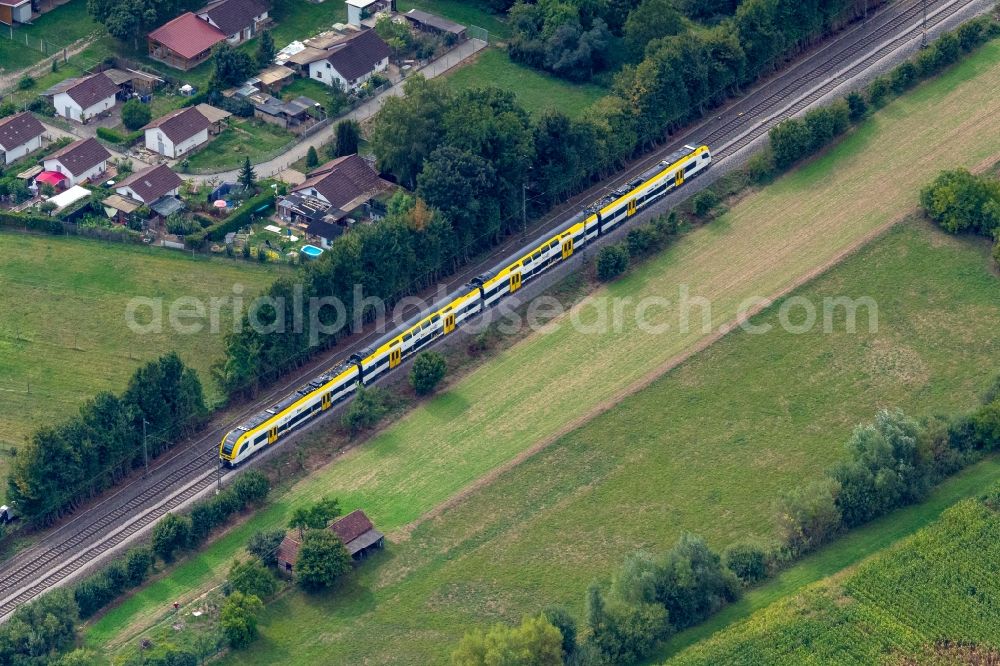 Teningen from the bird's eye view: Ride a train on the track Rheintalbahn in Teningen in the state Baden-Wuerttemberg, Germany