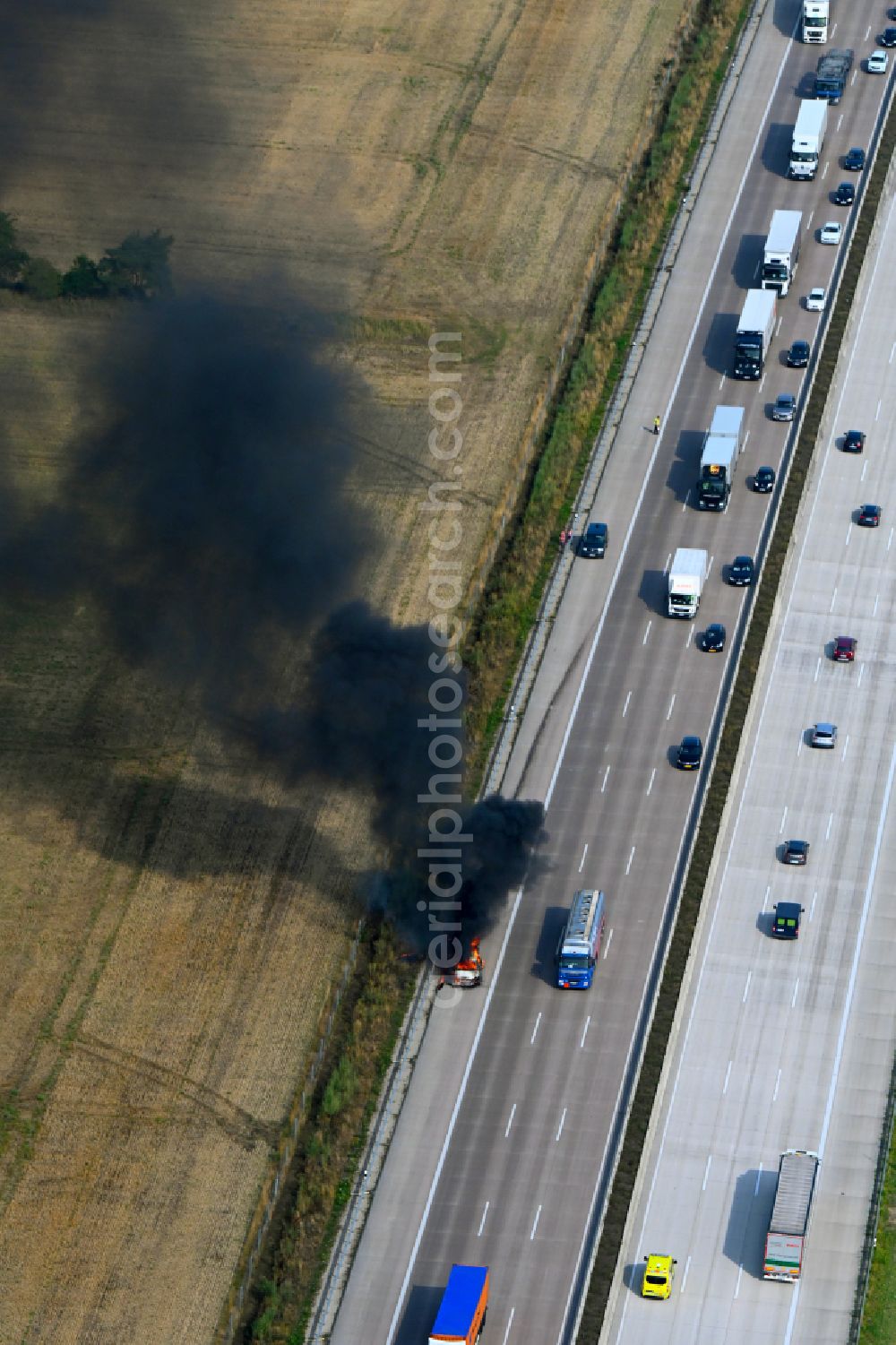 Aerial image Buchholz (Aller) - Smoke and flames from a motor vehicle fire in a passenger car on the A7 motorway in Buchholz (Aller) in the state Lower Saxony, Germany