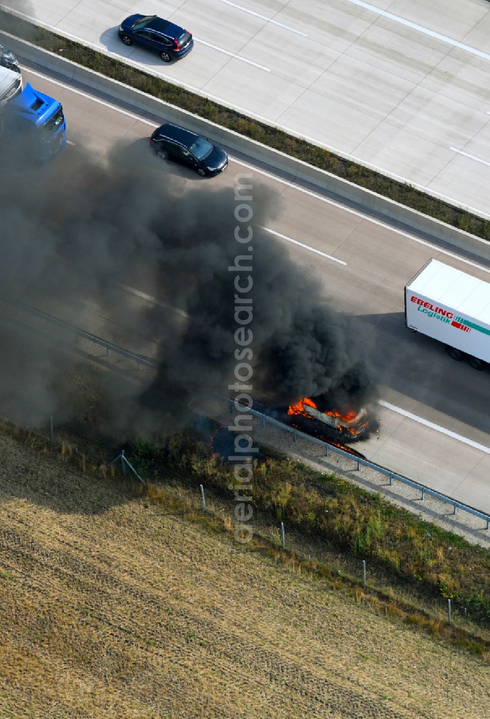Buchholz (Aller) from the bird's eye view: Smoke and flames from a motor vehicle fire in a passenger car on the A7 motorway in Buchholz (Aller) in the state Lower Saxony, Germany