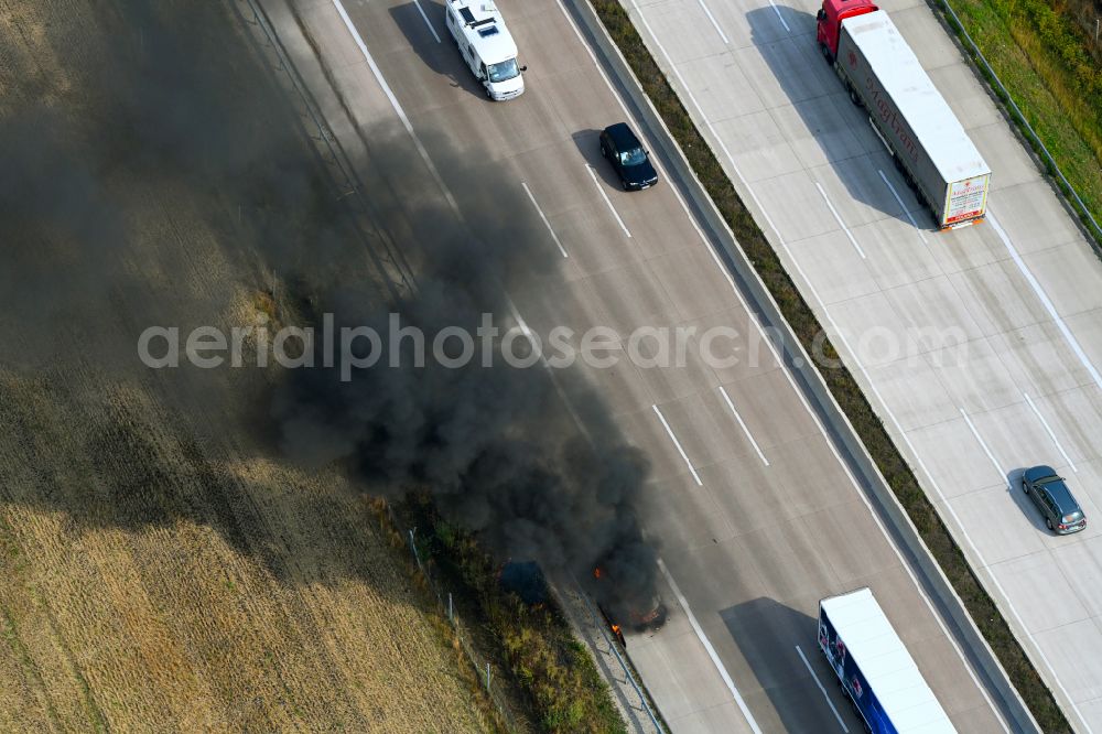 Aerial photograph Buchholz (Aller) - Smoke and flames from a motor vehicle fire in a passenger car on the A7 motorway in Buchholz (Aller) in the state Lower Saxony, Germany