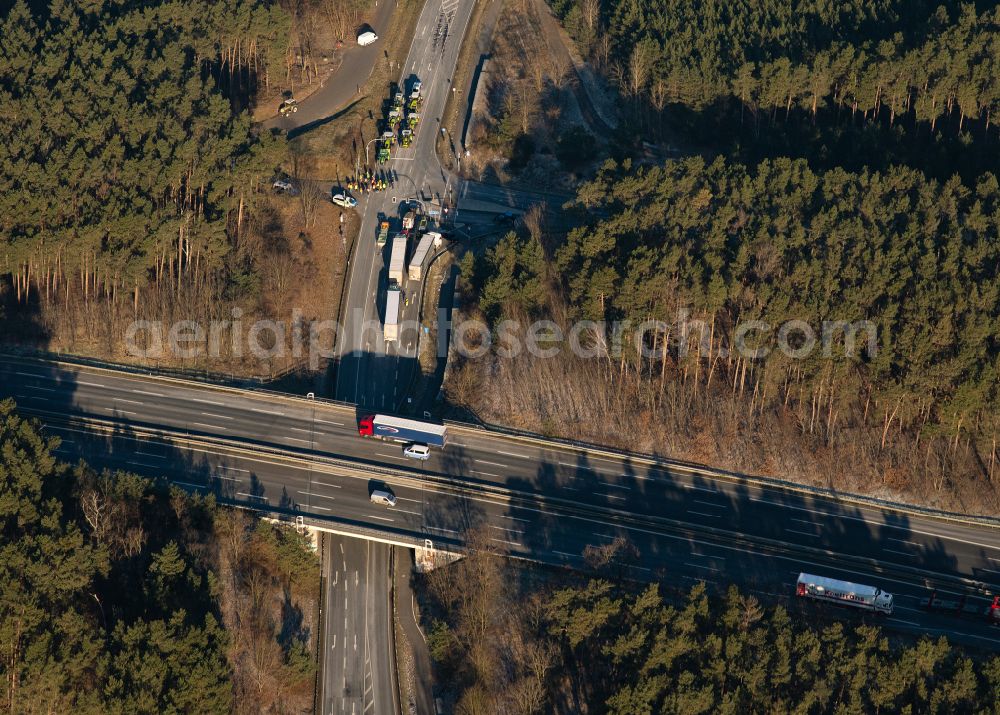 Aerial image Prützke - Vehicle convoy of participants in a political protest demonstration by farmers with their tractors at the motorway entrance and exit of the BAB A2 in Pruetzke in the state Brandenburg, Germany