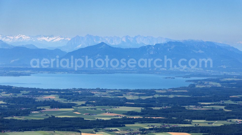 Übersee from above - Rock massif and mountain landscape of the Alps surround Lake Chiemsee in Uebersee in the state of Bavaria, Germany