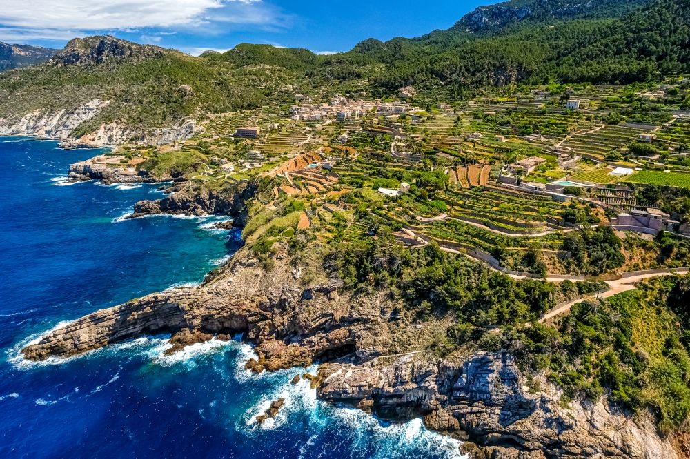 Aerial photograph Banyalbufar - Rock Coastline on the cliffs with stepped roads and residential areas in Banyalbufar in Balearic Islands, Spain