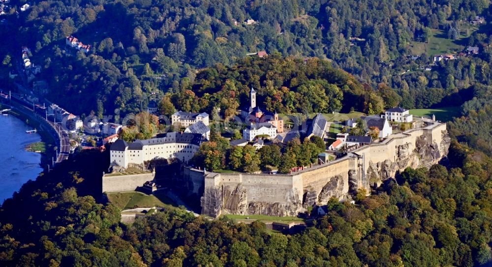 Königstein from the bird's eye view: The Fortress Koenigstein at the river Elbe in the county district of Saxon Switzerland East Erzgebirge in the state of Saxony. The fortress is one of the largest mountain fortresses in Europe and is located amidst the Elbe sand stone mountains on the flat top mountain of the same name