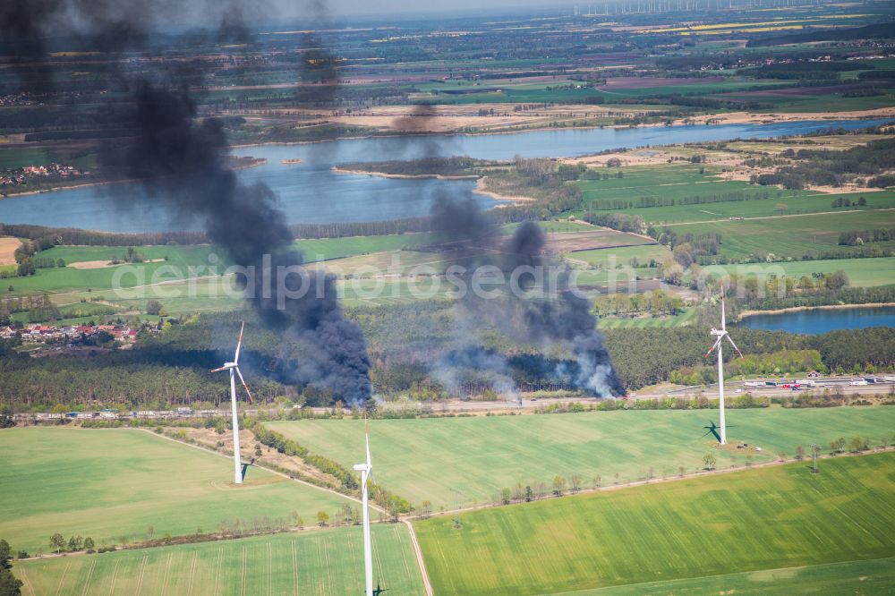 Aerial image Netzen - Accident damage to a truck burning with clouds of black smoke in road traffic along the Autobahn BAB A2 in Netzen in the state Brandenburg, Germany