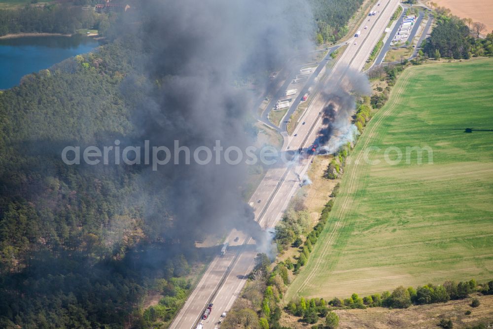 Netzen from above - Accident damage to a truck burning with clouds of black smoke in road traffic along the Autobahn BAB A2 in Netzen in the state Brandenburg, Germany