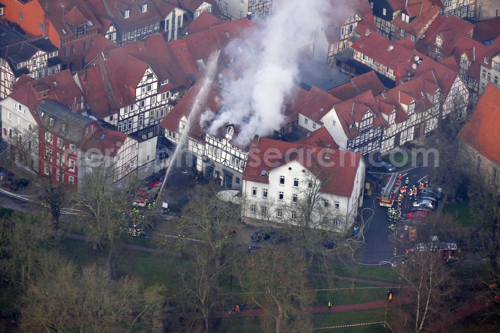 Hann. Münden from the bird's eye view: Extinguishing action of the fire brigade at the source of the fire and smoke formation in an apartment building Aegidiiplatz corner Wallstrasse in Hann. Muenden in the state Lower Saxony, Germany