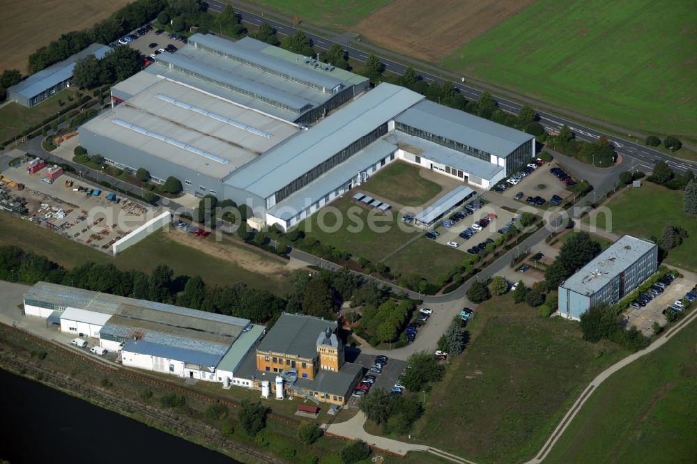 Bad Düben from above - Company compound and building complex of Profiroll Technologies in Bad Dueben in the state of Saxony. The compound includes production halls and administrative buildings as well as a parking lot and is located on federal highway B2 in the West of the town