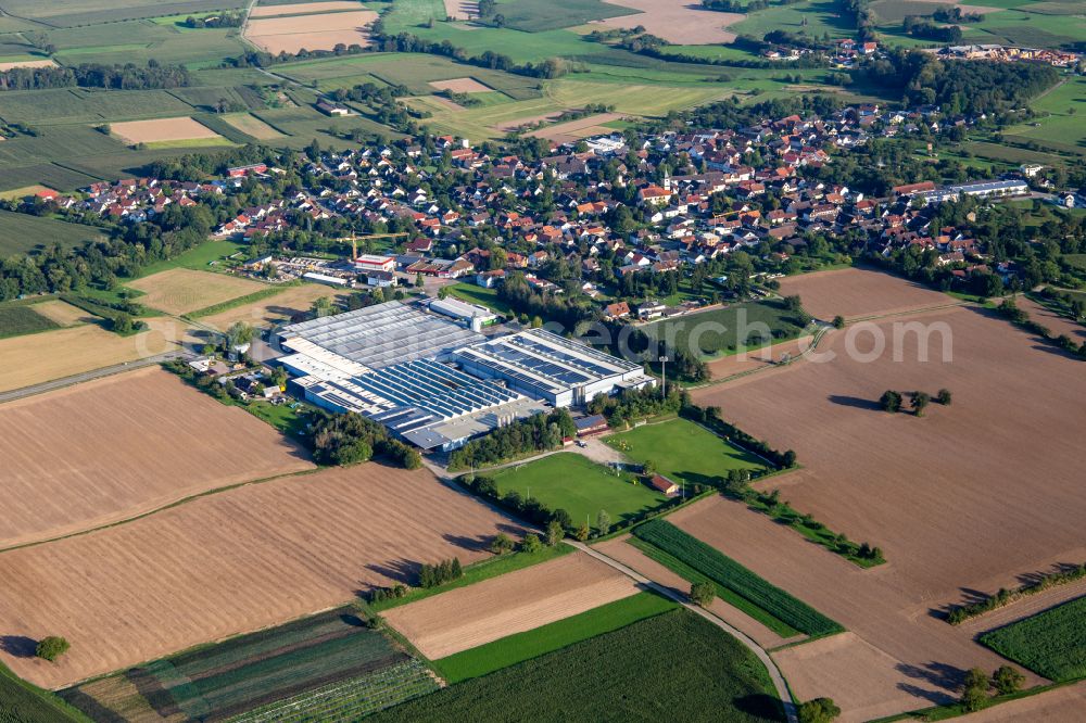 Lichtenau from the bird's eye view: Company grounds and facilities of Mecalit GmbH Kunststoffverarbeitung and of Fa. Siereg and sport fields of SV Scherzheim in Lichtenau in the state Baden-Wuerttemberg, Germany