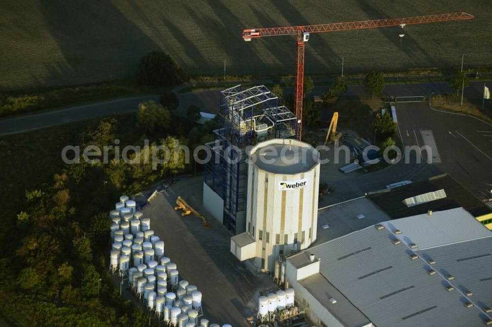 Rüdersdorf bei Berlin from above - Building and production halls on the premises of Saint-Gobain Weber GmbH in Ruedersdorf bei Berlin in the state of Brandenburg. The compound with the white silo and production facilities is located in the East of the Herzfelde part