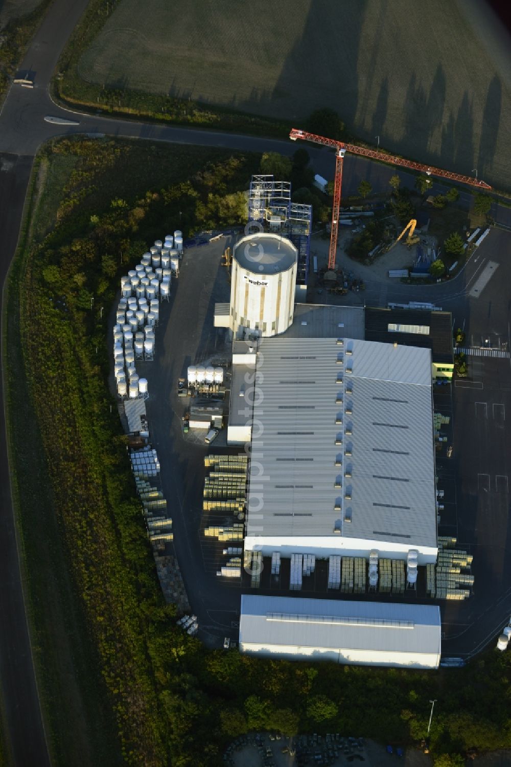 Aerial image Rüdersdorf bei Berlin - Building and production halls on the premises of Saint-Gobain Weber GmbH in Ruedersdorf bei Berlin in the state of Brandenburg. The compound with the white silo and production facilities is located in the East of the Herzfelde part
