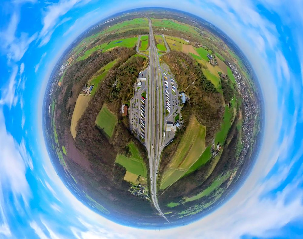 Hünxe from above - Fisheye perspective routing and traffic lanes during the motorway service station and parking lot of the BAB A 3 in Huenxe in the state North Rhine-Westphalia, Germany