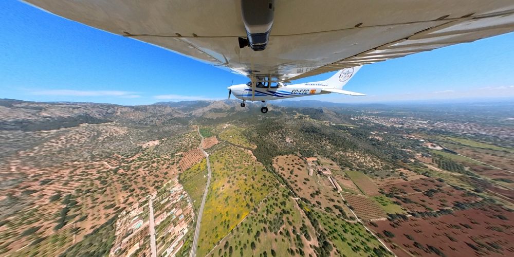 Aerial photograph Llubi - Fisheye perspective cessna 172 with the identifier EC-ETC Aircraft in flight over the airspace in Llubi in Balearic island of Mallorca, Spain