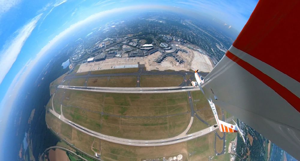Düsseldorf from above - Fisheye perspective runway with hangar taxiways and terminals on the grounds of the airport in Duesseldorf at Ruhrgebiet in the state North Rhine-Westphalia