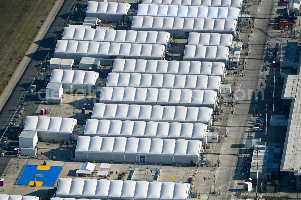 Berlin from the bird's eye view: Night lights and lighting refugee home and asylum accommodation tent camp as makeshift accommodation Ukraine Arrivals Center TXL in the district of Tegel in Berlin, Germany