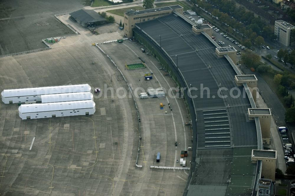 Aerial photograph Berlin - Premises of the former airport Berlin-Tempelhof Tempelhofer Freiheit in the Tempelhof part of Berlin, Germany. Its hangars are partly used as refugee and asylum seekers accommodations