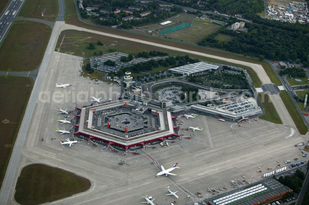 Berlin from above - Tegel Airport - Otto Lilienthal - is an international airport in Berlin in the state of Berlin. Core of the system is an ensemble of five terminal buildings and the Tower. The resort is surrounded by the runway. Passengers have a comfortable journey, because cars can drive up to the check-in desk immediately. The innovative concept developed the architects Gerkan, Marg and Partners
