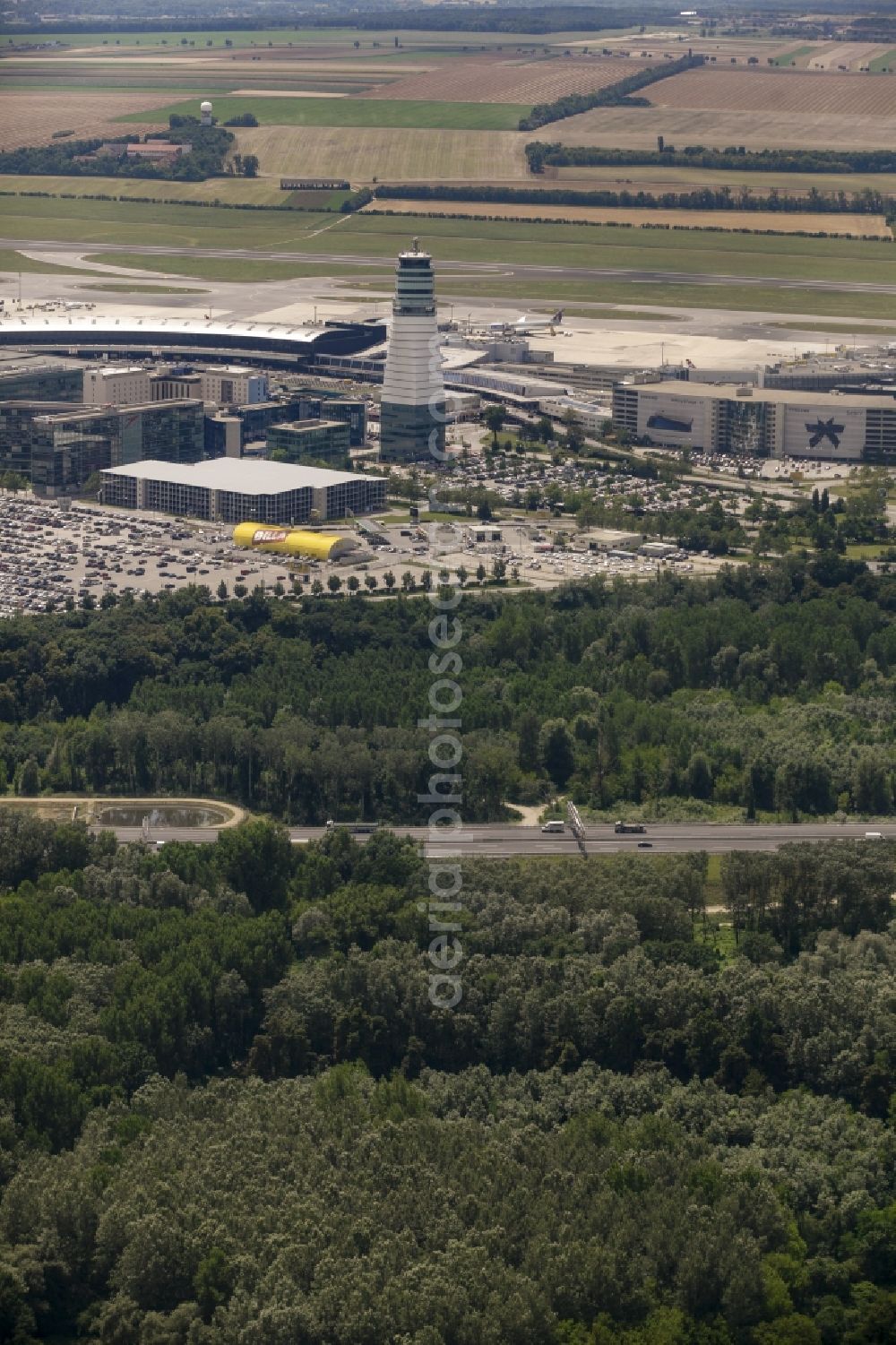 Aerial image Schwechat - Tower and terminals on the premises of Vienna International Airport in Schwechat in Lower Austria, Austria