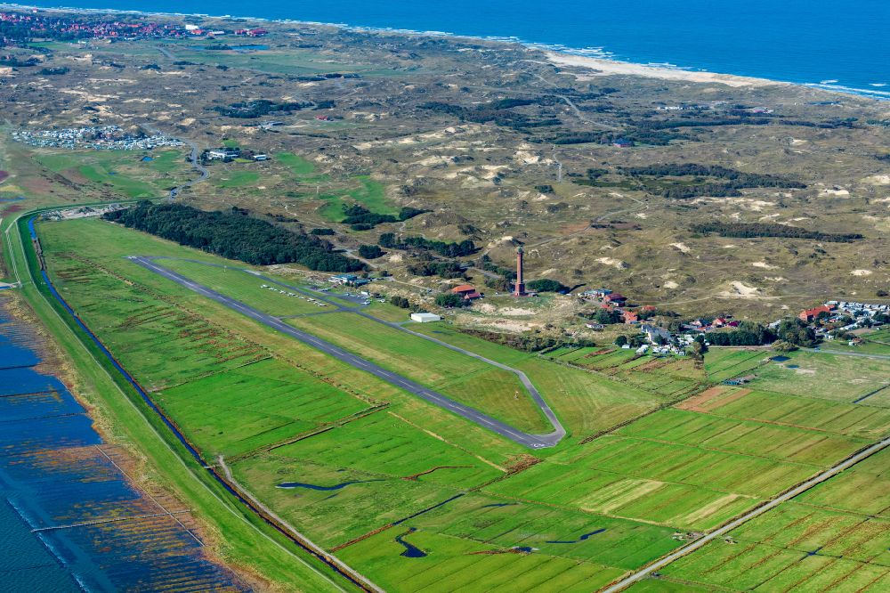 Norderney from the bird's eye view: Runway with tarmac terrain of airfield with dune landscape on Norderney island in the state Lower Saxony