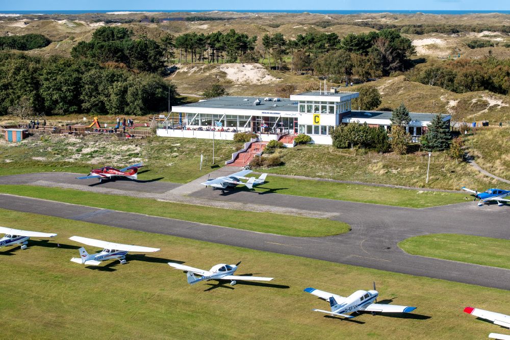 Norderney from above - Runway with tarmac terrain of airfield with dune landscape on Norderney island in the state Lower Saxony