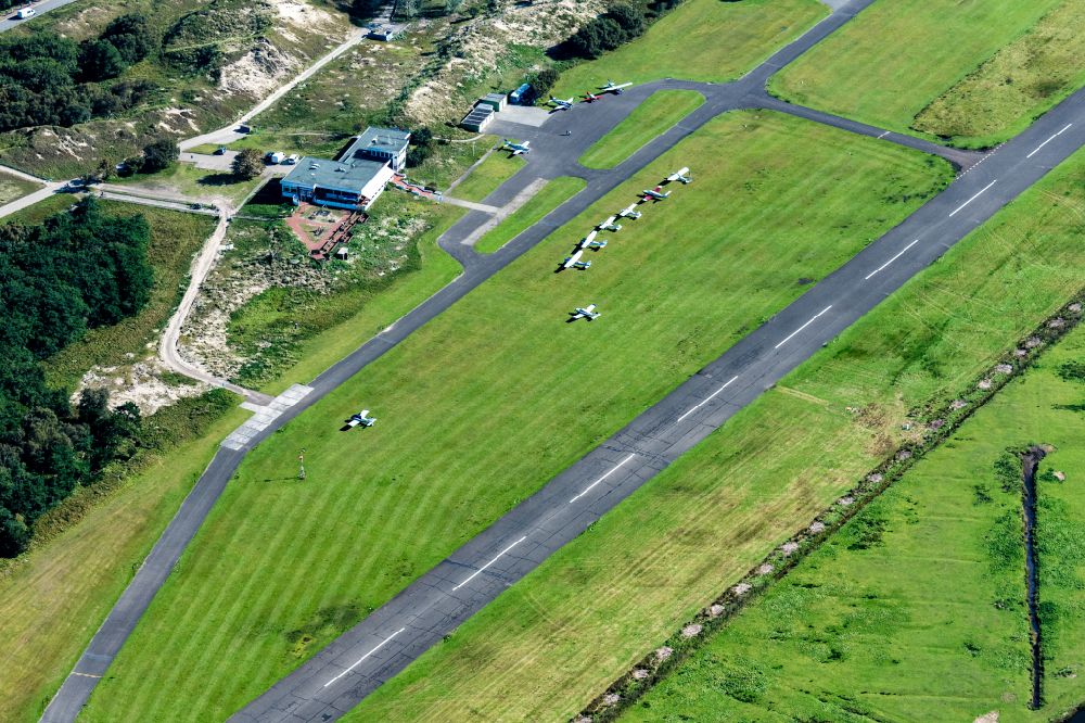 Norderney from above - Runway with tarmac terrain of airfield with dune landscape on Norderney island in the state Lower Saxony