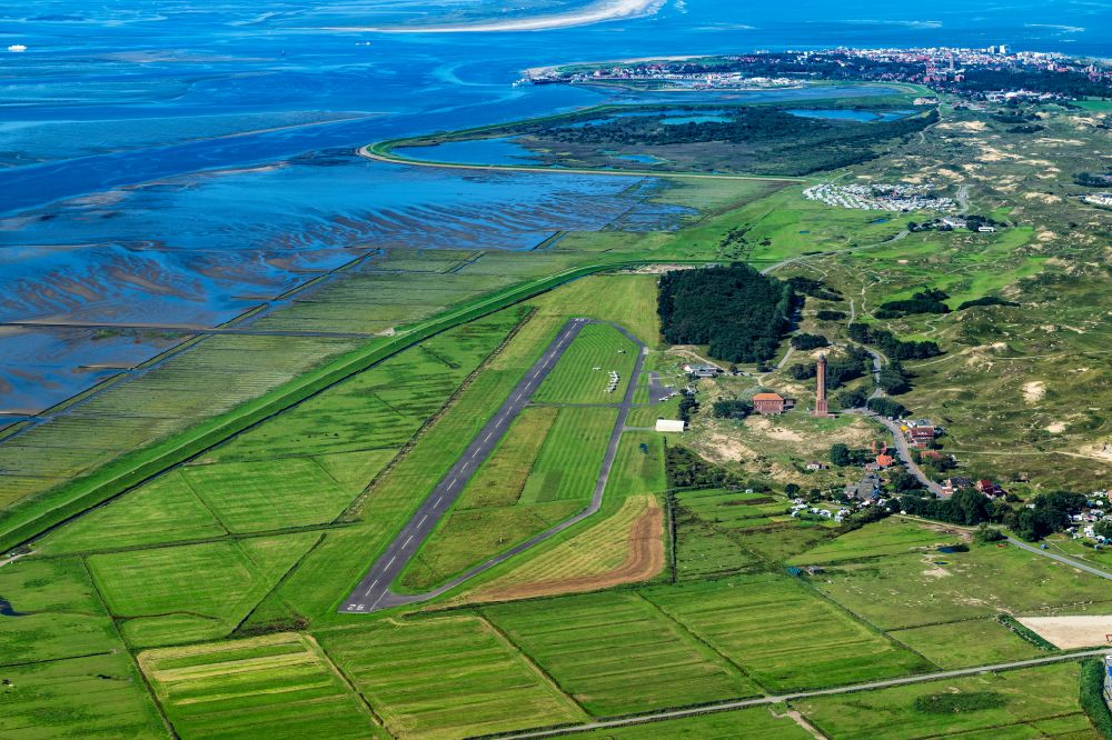 Norderney from the bird's eye view: Runway with tarmac terrain of airfield with dune landscape on Norderney island in the state Lower Saxony