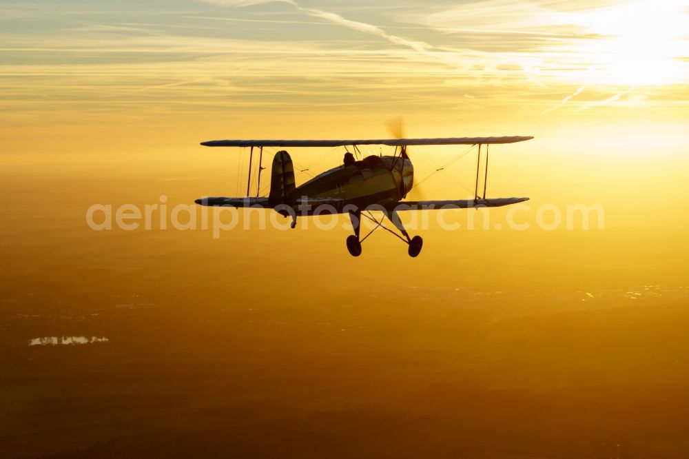 Kranenburg from the bird's eye view: Aircraft Buecker 131 in flight over the airspace in Kranenburg in the state of Lower Saxony, Germany. The Buecker Bue 131 Jungmann was the first aircraft of the aircraft manufacturer Buecker Flugzeugbau