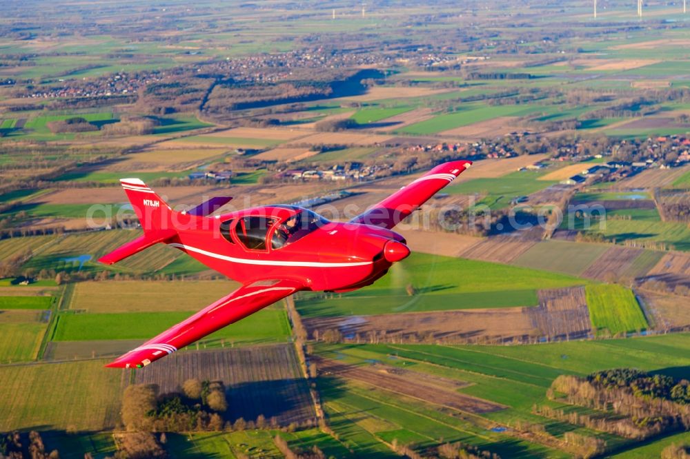 Aerial photograph Deinste - Glasair SH2R Aircraft in flight over the fields above Deinste in the state Lower Saxony, Germany
