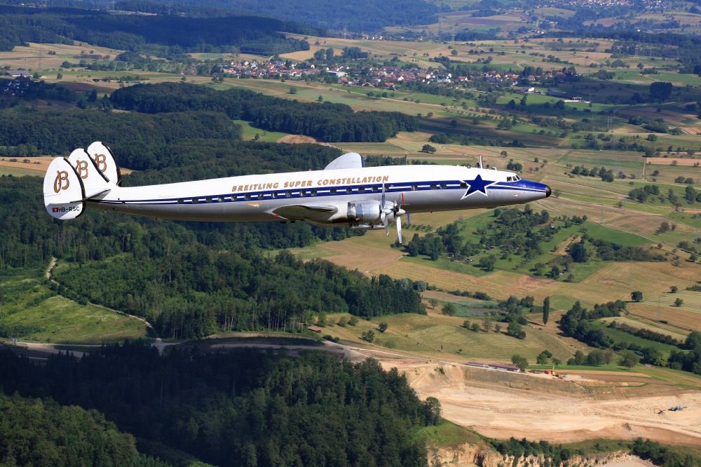 Aerial photograph Rheinfelden (Baden) - Lockheed L1049 Super Constellation Aircraft in flight in the airspace in Rheinfelden (Baden) in the state Baden-Wuerttemberg. The Breitling Super Constellation is one of yet only two flying aircraft in the world of this legendary airliner and belongs to the Super Constellation Flyers Association in Basle
