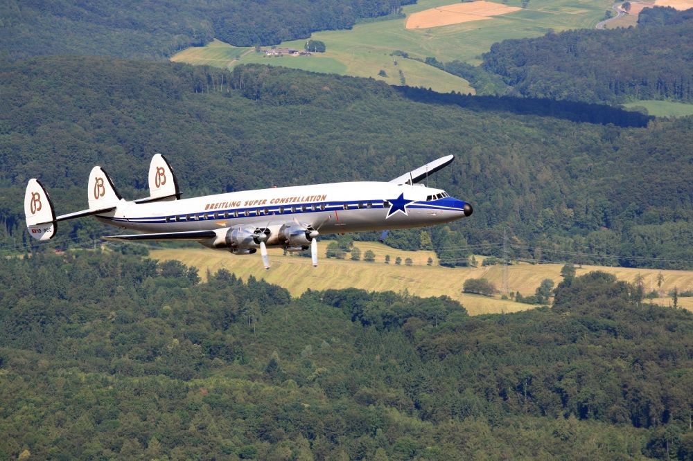Rheinfelden (Baden) from above - Lockheed L1049 Super Constellation Aircraft in flight in the airspace over Rheinfelden in the state Baden-wurttemberg. The Breitling Super Constellation is one of yet only two flying aircraft in the world of this legendary airliner and belongs to the Super Constellation Flyers Association at the Euroairport in Basle