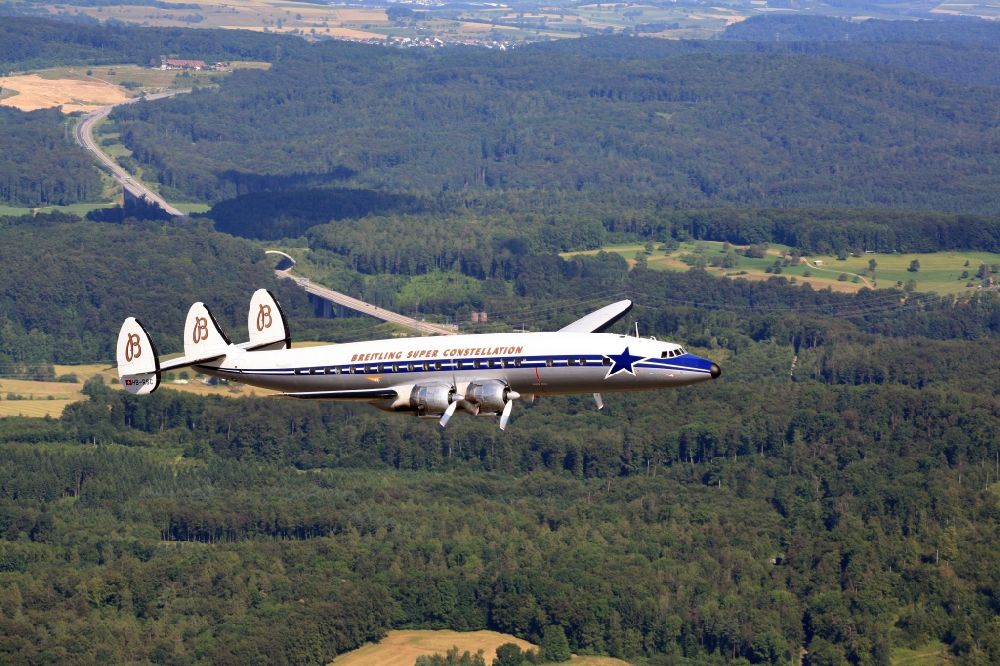Aerial photograph Rheinfelden (Baden) - Lockheed L1049 Super Constellation Aircraft in flight in the airspace over Rheinfelden in the state Baden-wurttemberg. The Breitling Super Constellation is one of yet only two flying aircraft in the world of this legendary airliner and belongs to the Super Constellation Flyers Association at the Euroairport in Basle