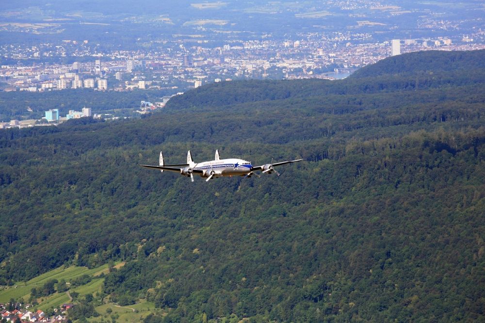 Aerial image Grenzach-Wyhlen - Lockheed L1049 Super Constellation Aircraft in flight in the airspace over Grenzach-Wyhlen in the state Baden-Wuerttemberg. The Breitling Super Constellation is one of yet only two flying aircraft in the world of this legendary airliner and belongs to the Super Constellation Flyers Association at the Euroairport in Basle