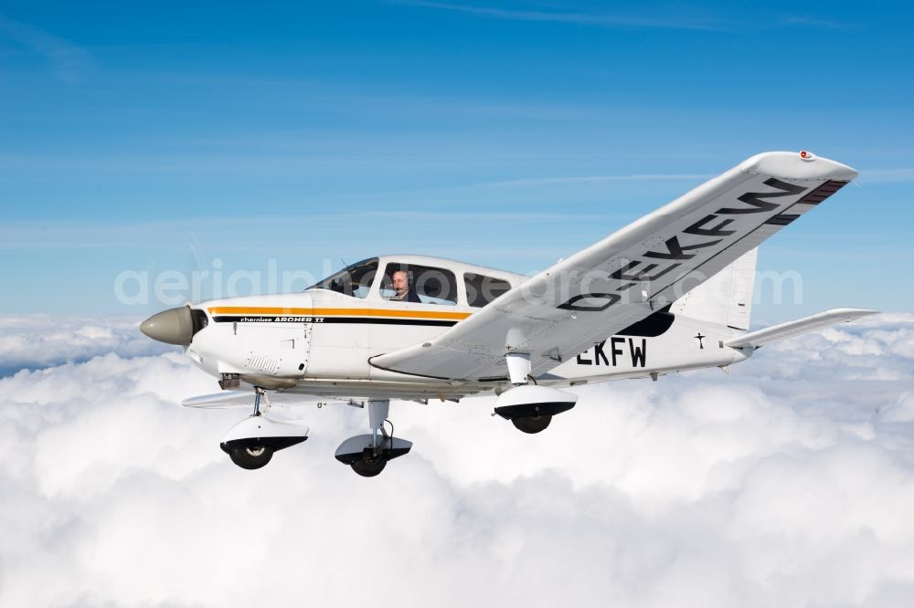 Gnarrenburg from above - Piper Pa28 Archer II D-EKFW Aircraft in flight above the clouds near Gnarrenburg in the state Lower Saxony, Germany. The Piper PA-28 Cherokee is a single-engine, four-seater light aircraft from the US aircraft manufacturer Piper Aircraft Corporation