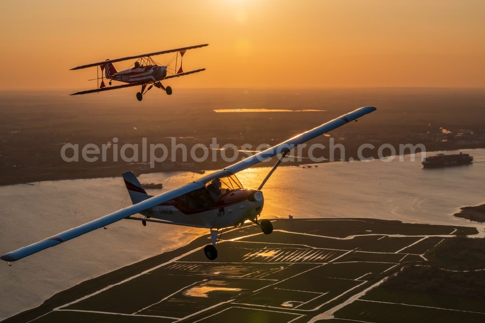 Wedel from the bird's eye view: Plane Sunwheel and FK 9 Aircraft in flight over the airspace in Wedel in the state Schleswig-Holstein, Germany