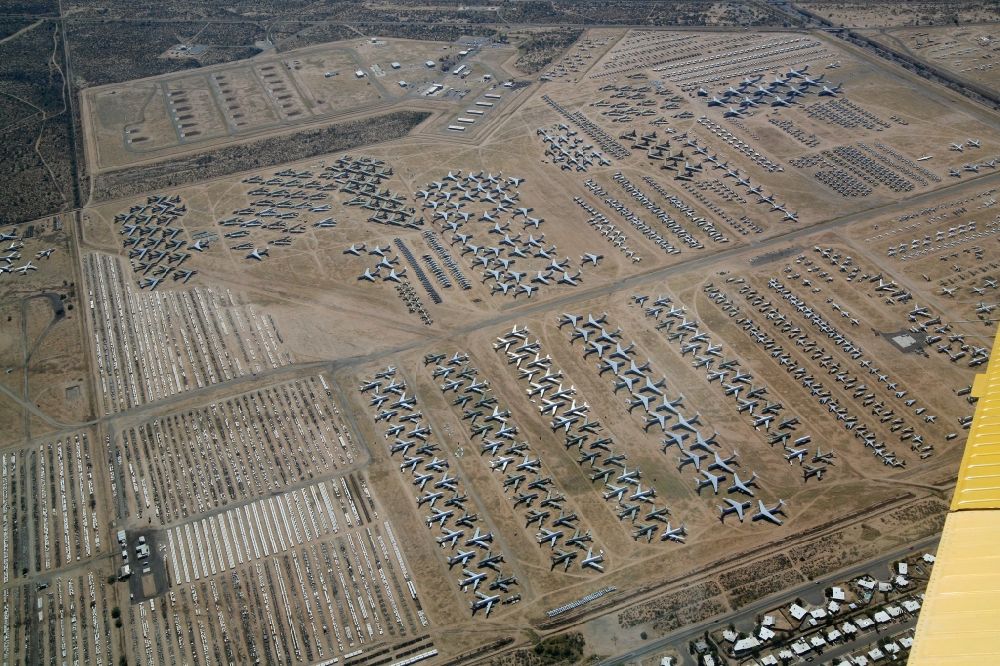 Aerial image Tucson - Tucson in Arizona in USA. In the desert climate of Arizona, the US has mothballed Air Force decommissioned aircraft. Waiting for the demolition or partly for reactivation. Among the aircraft are F14 Tomcat, RF4 Phantom, C-141 Starlifter, C130 Hercules, B52 bombers and B1 swing wing bombers. The area is located next to the Davis-Monthan Air Force Base and is subordinated to the Air Force Materiel Command (AFMC) of the US Air Force