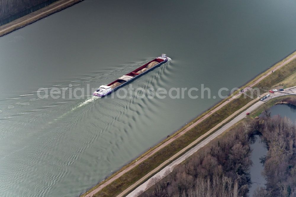 Daubensand from the bird's eye view: Cargo ships and bulk carriers on the inland shipping waterway of the river course of the Rhine river in Daubensand in Grand Est, France