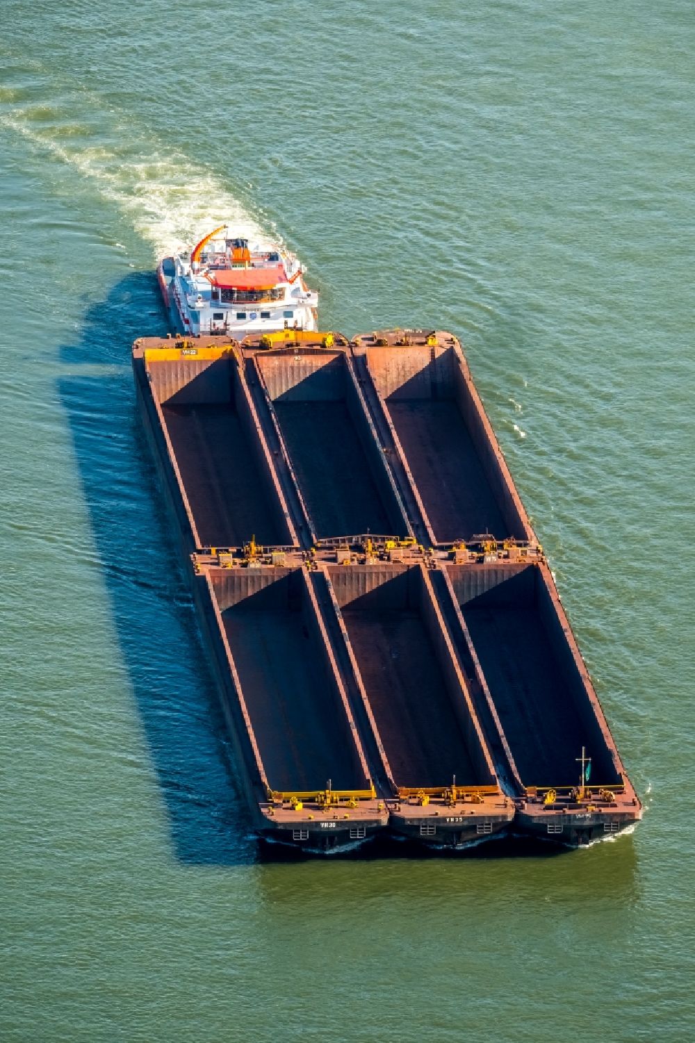 Xanten from the bird's eye view: Cargo ships and bulk carriers on the inland shipping waterway of the river course of the Rhine river in Xanten in the state North Rhine-Westphalia, Germany