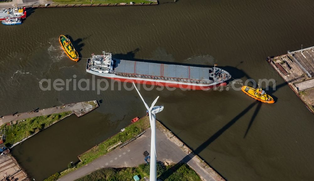 Husum from the bird's eye view: Cargo ship and bulk freighter on the Husumer Au with tugboat help in the port of Husum in the state Schleswig-Holstein, Germany