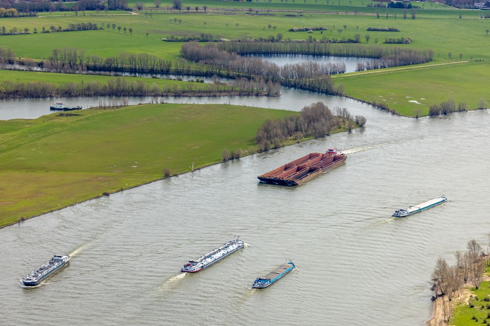 Rees from above - Cargo ships and bulk carriers on the inland shipping waterway of the river course of the Rhine river in Rees in the state North Rhine-Westphalia, Germany