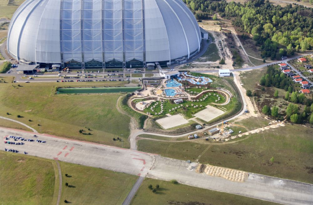 Aerial image Krausnick - Complete complex of the Theme Park Tropical Islands with air hall, outdoor pool, campsite, holiday homes and former airfield on street Tropical-Islands-Allee in Krausnick in the state of Brandenburg, Germany