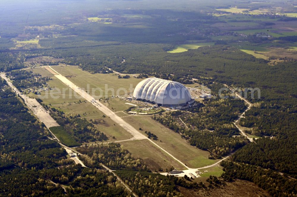 Krausnick from above - Complete complex of the Theme Park Tropical Islands with air hall, outdoor pool, campsite, holiday homes and former airfield on street Tropical-Islands-Allee in Krausnick in the state of Brandenburg, Germany