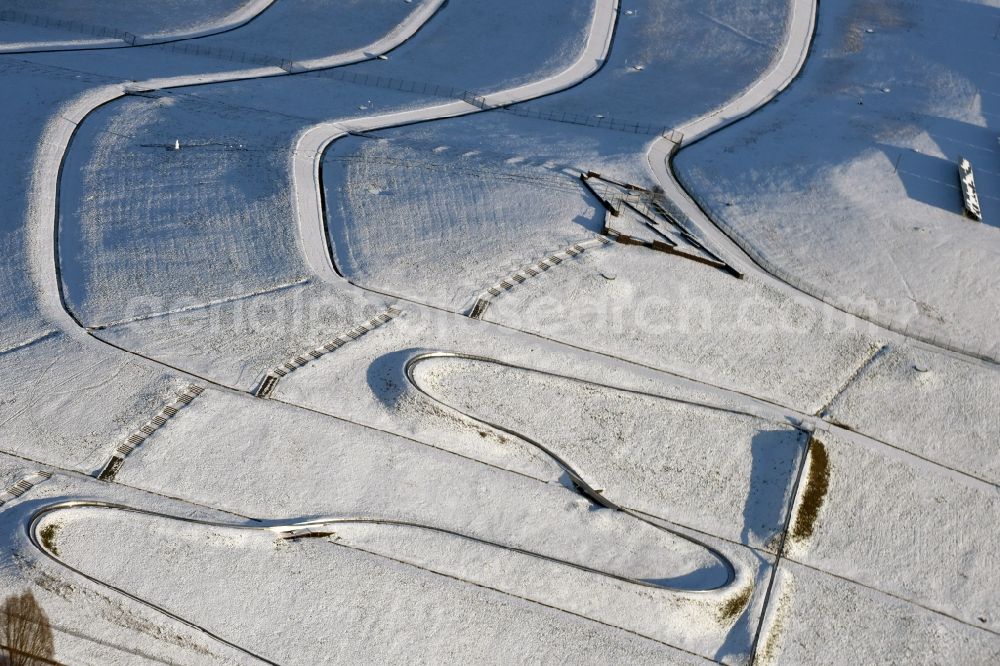 Magdeburg from above - Wintry snowy curve Amusement Park of Sommerrodelbahn in Elbauenpark in Magdeburg in the state Saxony-Anhalt