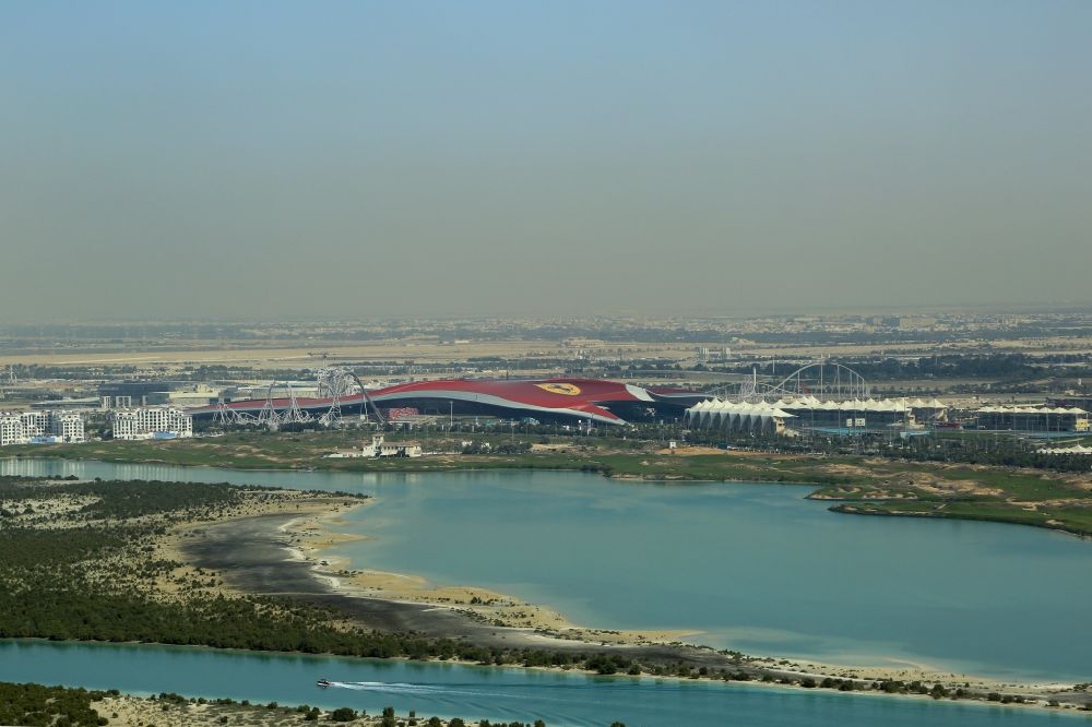 Abu Dhabi from the bird's eye view: Leisure Centre - Amusement Park at Yas Island with Ferrari World and roller coaster Formula Rossa at the Formula 1 race track Yas Marina Circuit in Abu Dhabi in United Arab Emirates