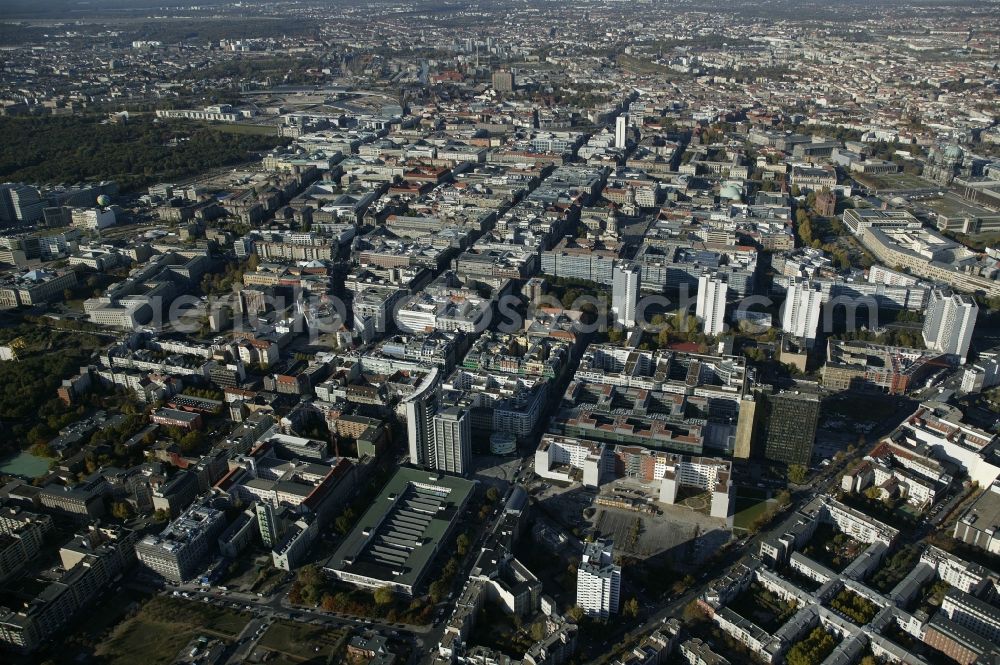 Berlin from the bird's eye view: Between the parallel business Friedrichstrasse, Glinka Street, Wilhelm Street and Markgrafenstrasse in Berlin in the state of Berlin, the historic Friedrichstadt extends. This attractive residential and commercial district is characterized by a mix of quality real estate and major attractions such as the ensemble of buildings on the Gendarmenmarkt with the Konzerthaus Berlin, German and French Cathedrals. Specifically, the Friedrichstrasse is a popular shopping street. At its northern end is the high-rise International Trade Centre. East of the government district with the Reichstag building is the high-rise Charite. In the Wilhelmstrasse, the Federal Ministry of Finance is defined by its distinctive architecture. In the east at the Friedrichstadt to the UNESCO World Heritage Museum Island with Old- and New Museum, Pergamon Museum and Berlin Cathedral. In the photo is still the Palace of the Republic to be recognized. South of the Zimmer road in the Kreuzberg district, the Axel-Springer premises and the high-rise housing company GSW dominate