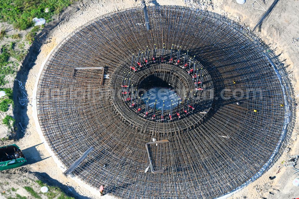 Listerfehrda from the bird's eye view: Construction site for the construction of a steel and concrete foundation in a circular shape as a base for the installation of a WEA wind turbine - wind turbine on a field in Listerfehrda in the state Saxony-Anhalt, Germany