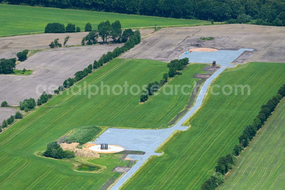 Aerial photograph Wittbek - Construction site for the construction of a steel and concrete foundation in a circular shape as a base for the installation of a WEA wind turbine - wind turbine on a field in Wittbek in the state Schleswig-Holstein, Germany