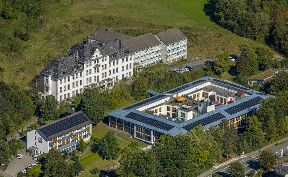 Elspe from the bird's eye view: Building of the retirement home - senior residence of the Caritas-Tagespflege Elspe with a view of the ruins of the old St. Franziskus-Haus on Bielefelder Strasse in Elspe in the state North Rhine-Westphalia, Germany