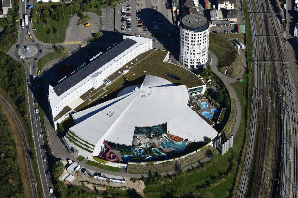 Aerial photograph Pratteln - Building, pools and water slide of Water World Aquabasilea in Pratteln in the canton Basel-Landschaft, Switzerland. The round building in the neighborhood is the corporate headquarter of Clariant AG